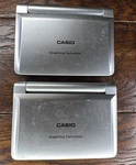 2 Casio FX-9860G Slim Graphing Calculator Compact Size (some Minor Scratches). Fixed Price $90.00.